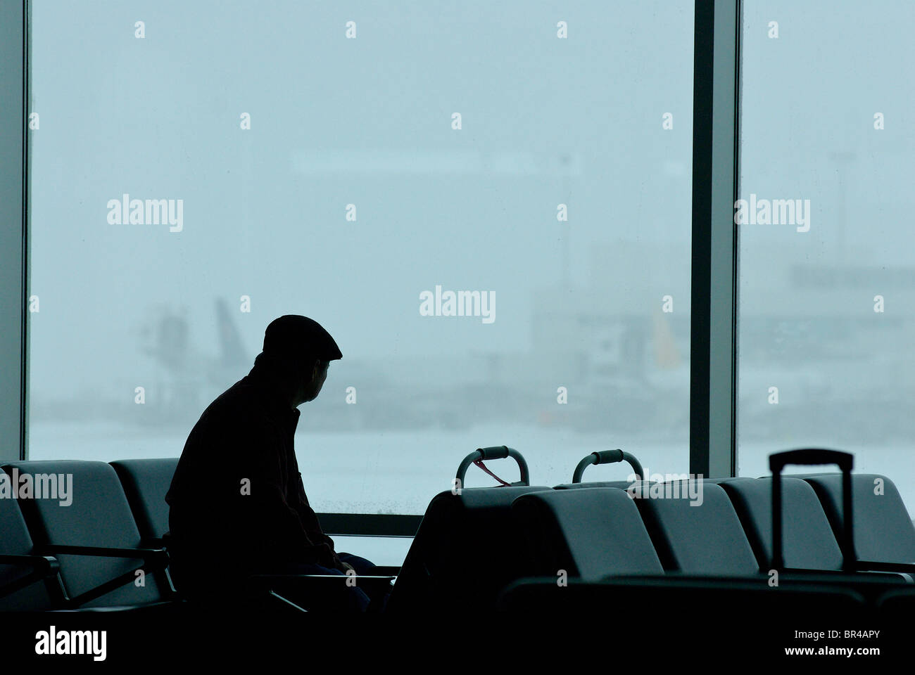 A passenger waiting in an airport. Stock Photo