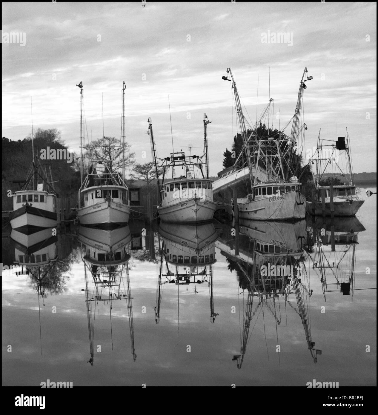 Old fishing boats docked in a calm harbor, Apalachicola, Florida Stock