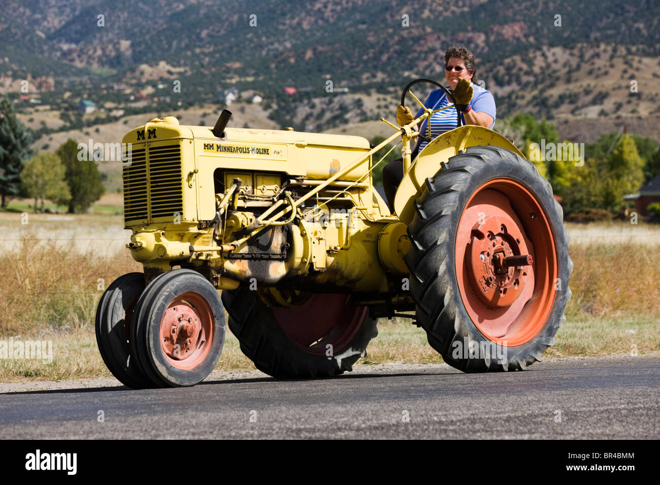 Wedding procession, rancher riding on antique tractor from the church to the reception, Salida, Colorado, USA Stock Photo