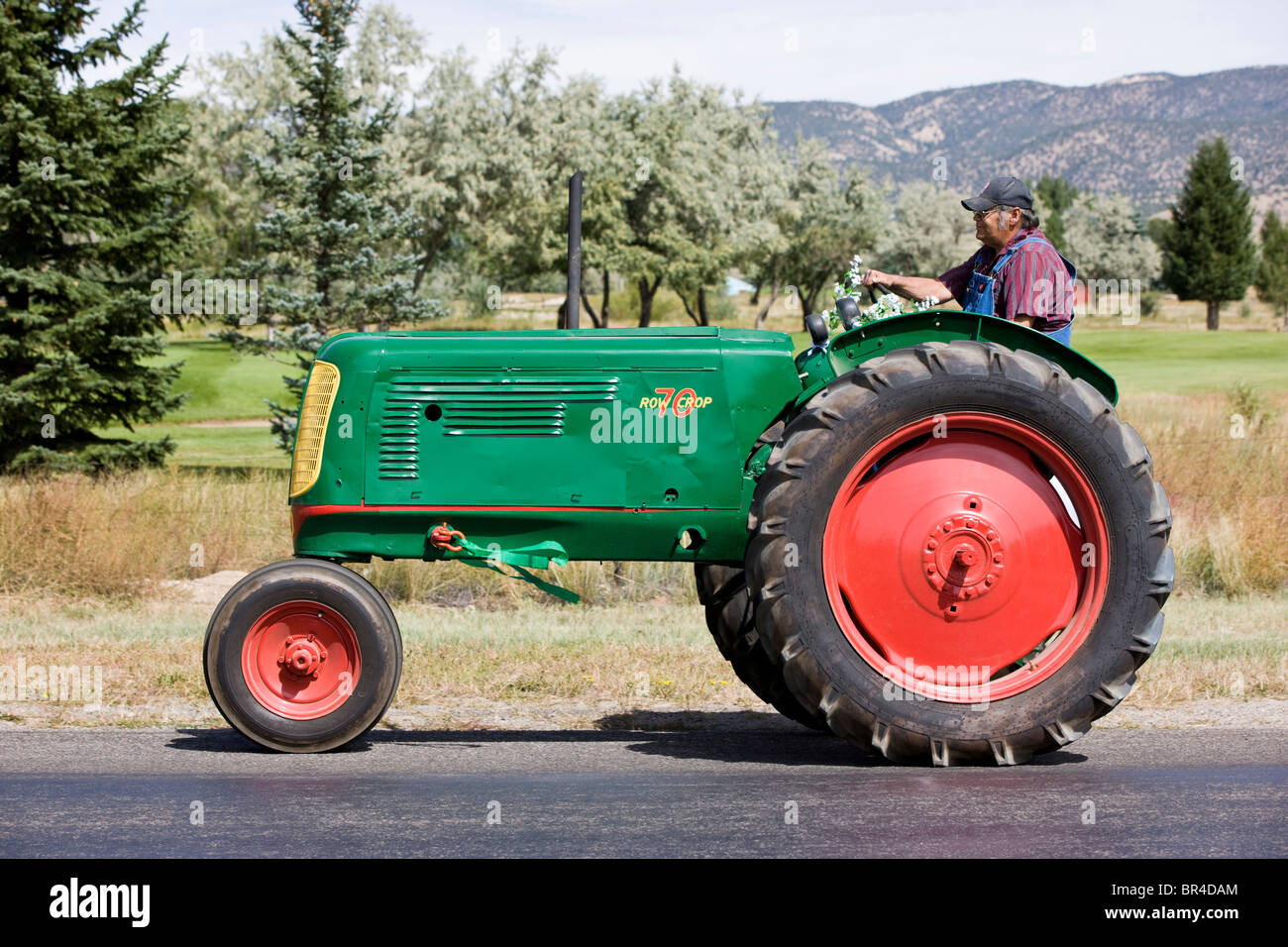 Wedding procession, rancher riding on antique tractor from the church to the reception, Salida, Colorado, USA Stock Photo