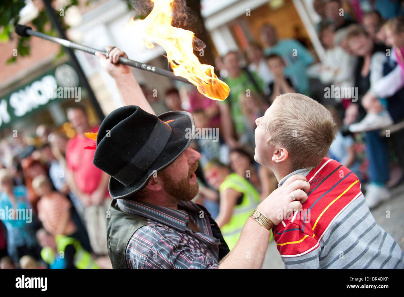A young boy with fire eater at Shrewsbury International Street Theatre Festival, Shropshire, UK Stock Photo