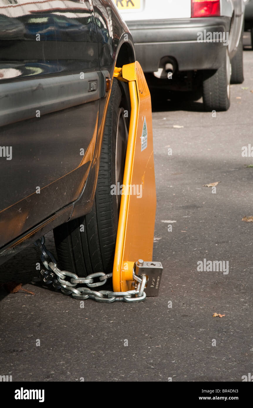 Illegal, untaxed and wheel clamped car in public street Stock Photo Alamy