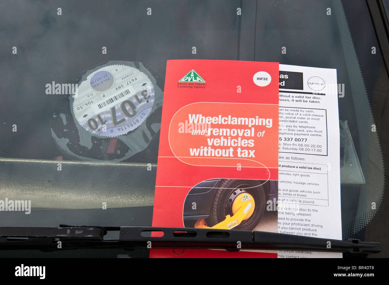 Illegal, untaxed and wheel clamped car in public street Stock Photo Alamy