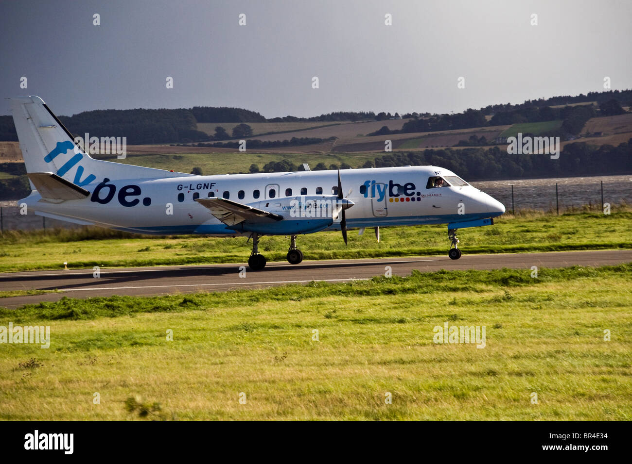 Flybe SAAB 340 turboprop plane accelerating along the runway at Dundee airport,UK Stock Photo