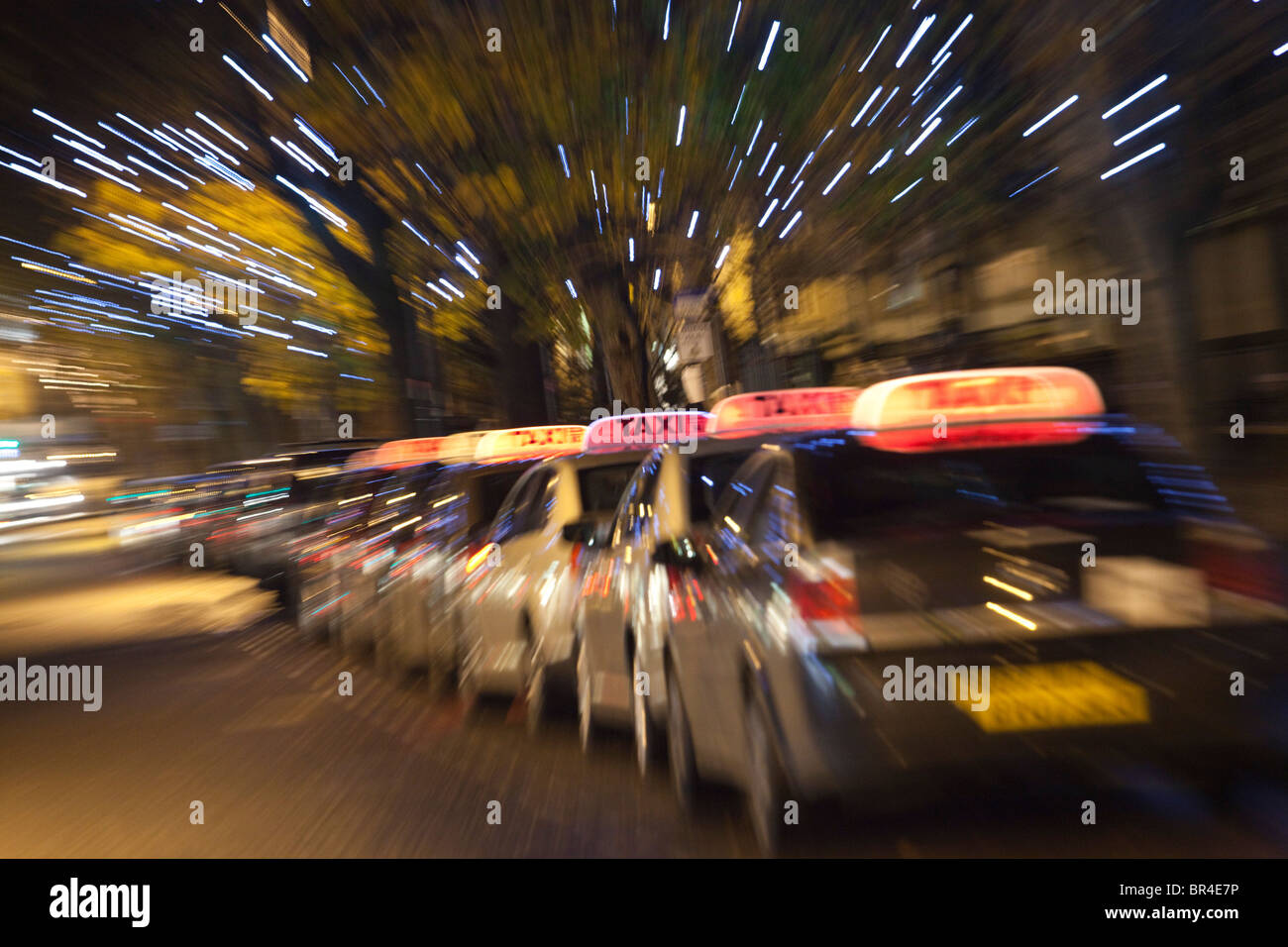 A taxi rank at night with christmas lights, Cheltenham, Gloucestershire, UK Stock Photo