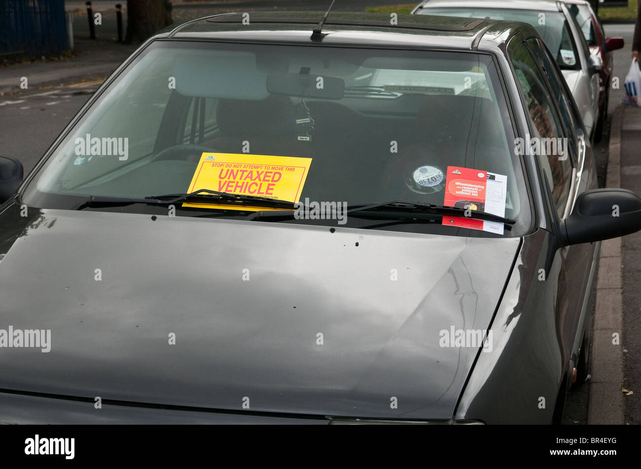 Illegal, untaxed and wheel clamped car in public street Stock Photo Alamy