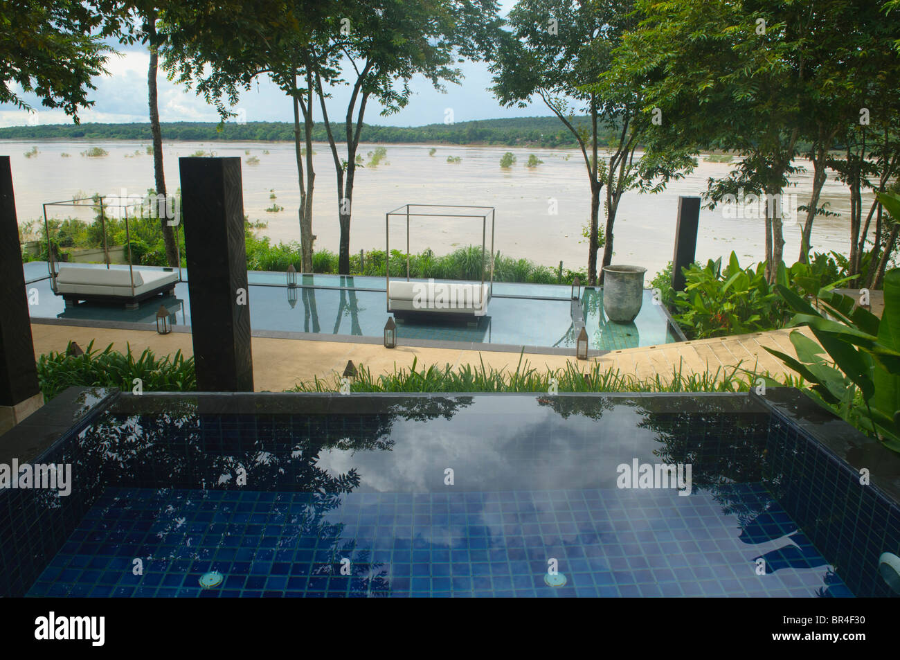 looking out at Laos and the Mekong River from an infinity edge pool in Thailand Stock Photo