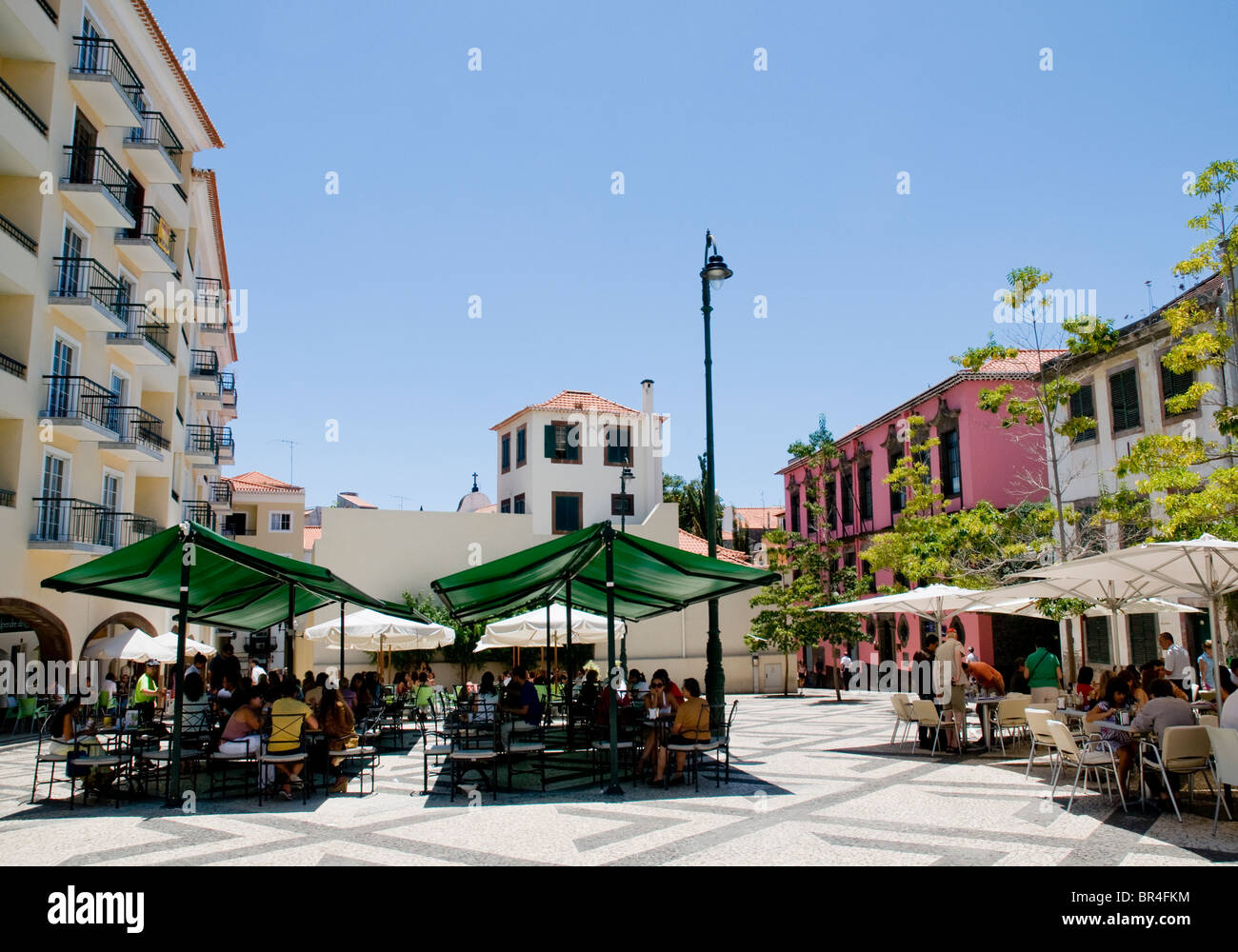 Covered restaurant terraces in a quiet backstreet square in central Funchal, on the island of Madeira. Stock Photo