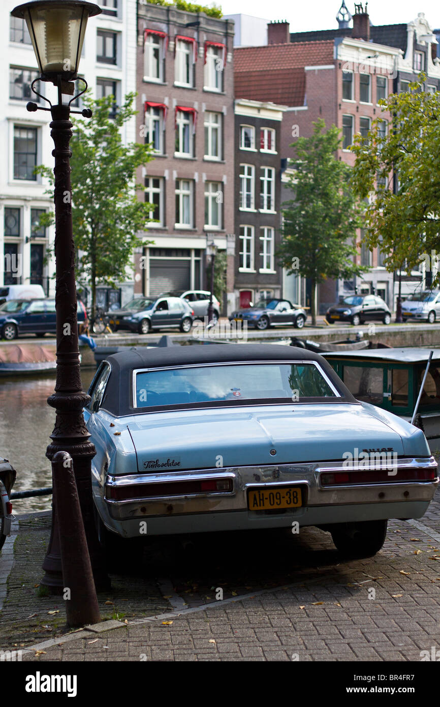 Old classic Buick car parked by canal in Amsterdam, Holland Stock Photo