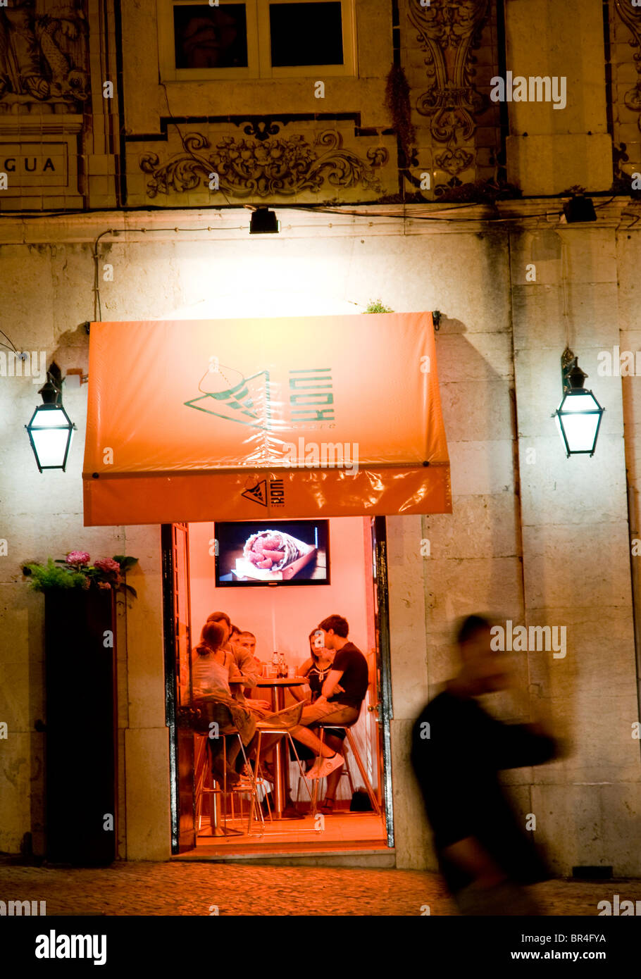 A Lisbon café-bar at night, frequented by teenagers enjoying a drink and good company. Stock Photo
