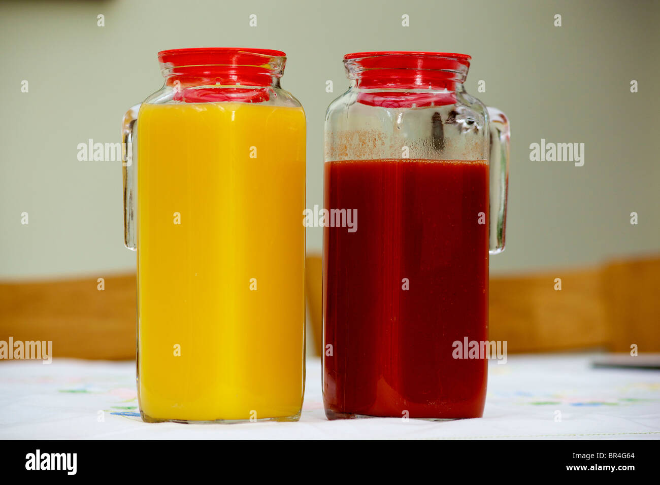 https://c8.alamy.com/comp/BR4G64/two-glass-jugs-full-of-fruit-juice-orange-and-tomato-BR4G64.jpg