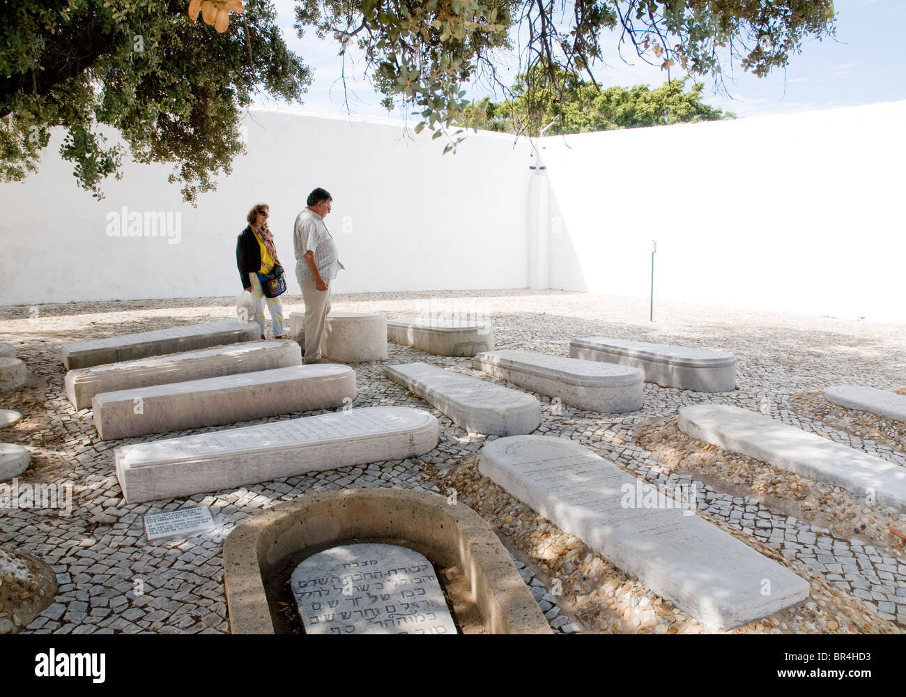 An elderly couple visiting the Jewish Cemetery at Faro, in southern Portugal´s Algarve province. Stock Photo