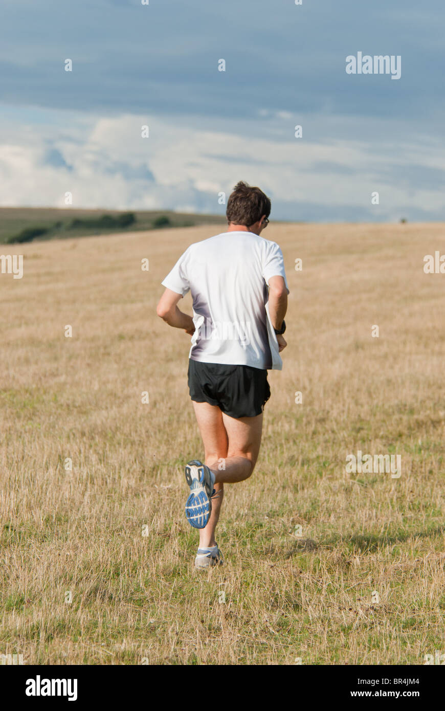 cross country runner running on hills Stock Photo Alamy