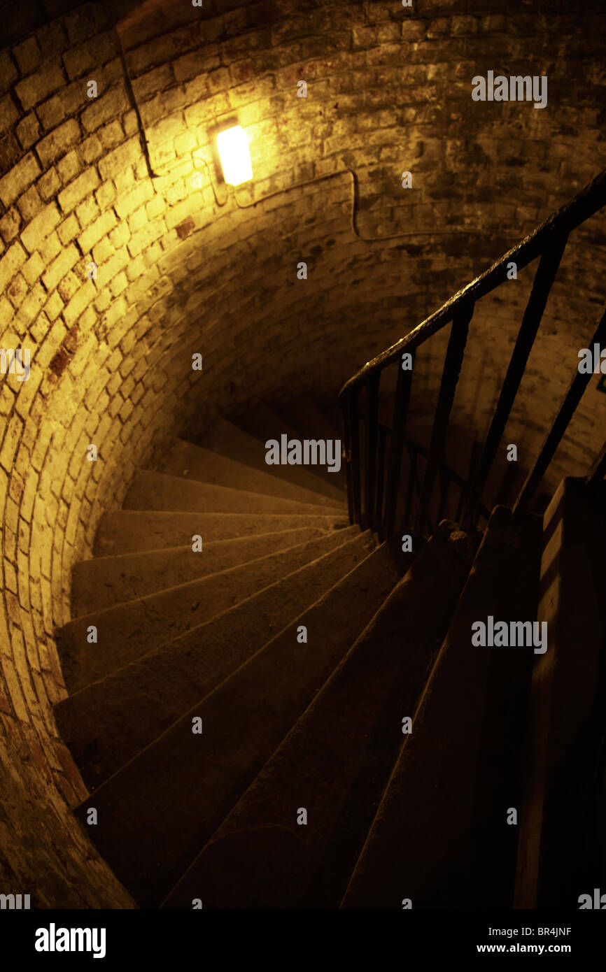 Stone spiral staircase in an underground fort Stock Photo
