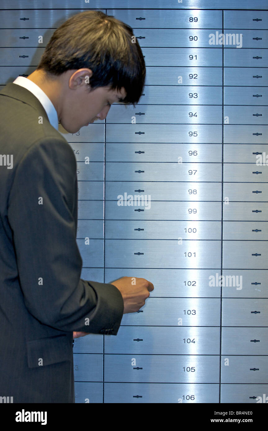 Man opening safe deposit box Stock Photo Alamy