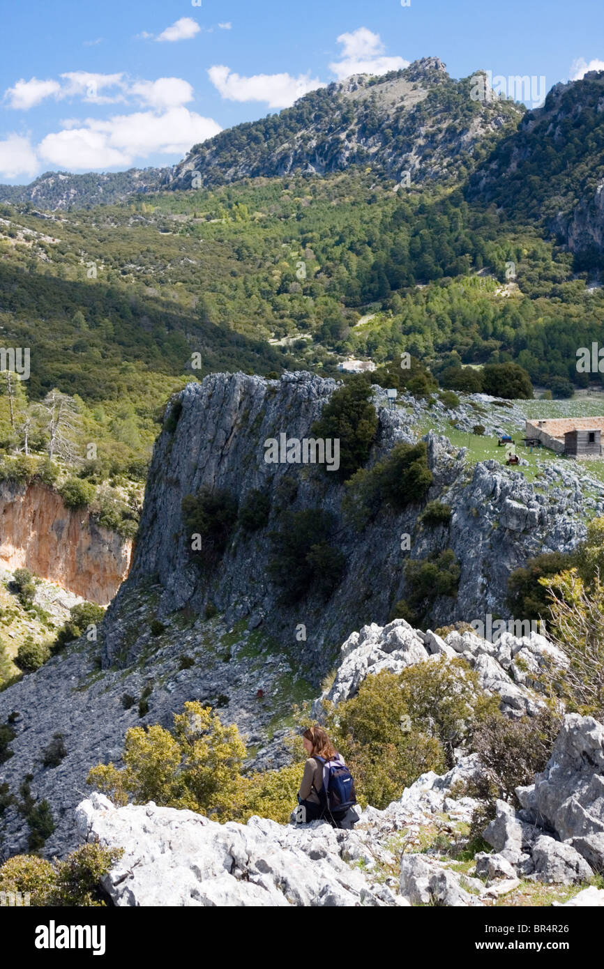 Hiker looking at a beautiful view of limestone cliffs and green hillside, Cazorla National Park, Jaen Province, Andalucia, Spain Stock Photo