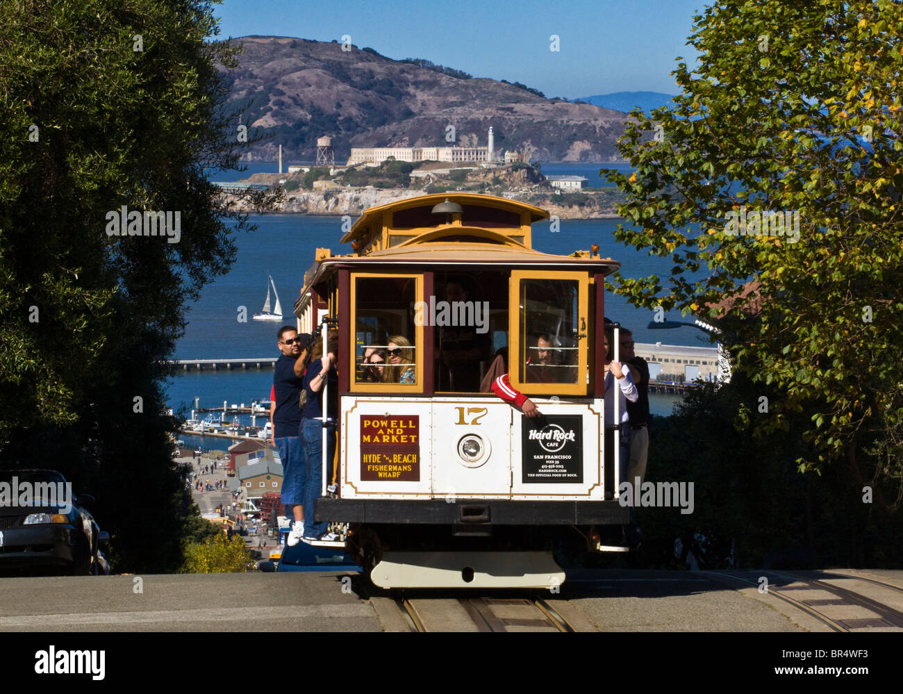 A POWELL and MARKET CABLE CAR with a view of ALCATRAZ ISLAND - SAN FRANCISCO, CALIFORNIA Stock Photo