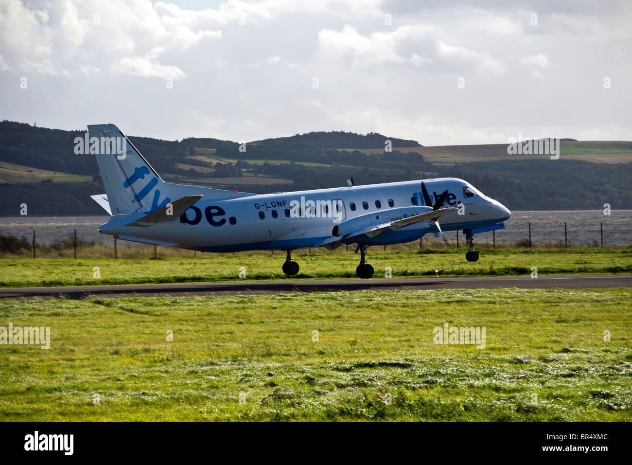 Flybe SAAB 340 turboprop plane leaving the runway after take off from Dundee airport,UK Stock Photo