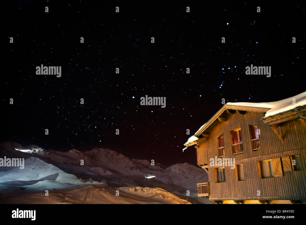 Chalet in the Alps at night with stars and snow Val Thorens France Stock Photo