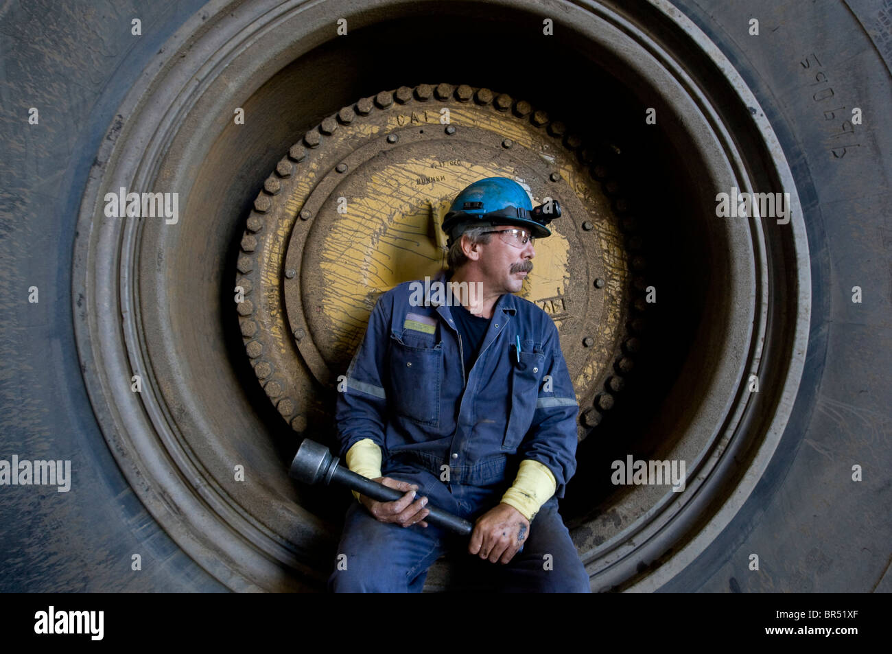 Truck repairman and large truck tire Suncor Facility north of Fort McMurray Alberta Canada Stock