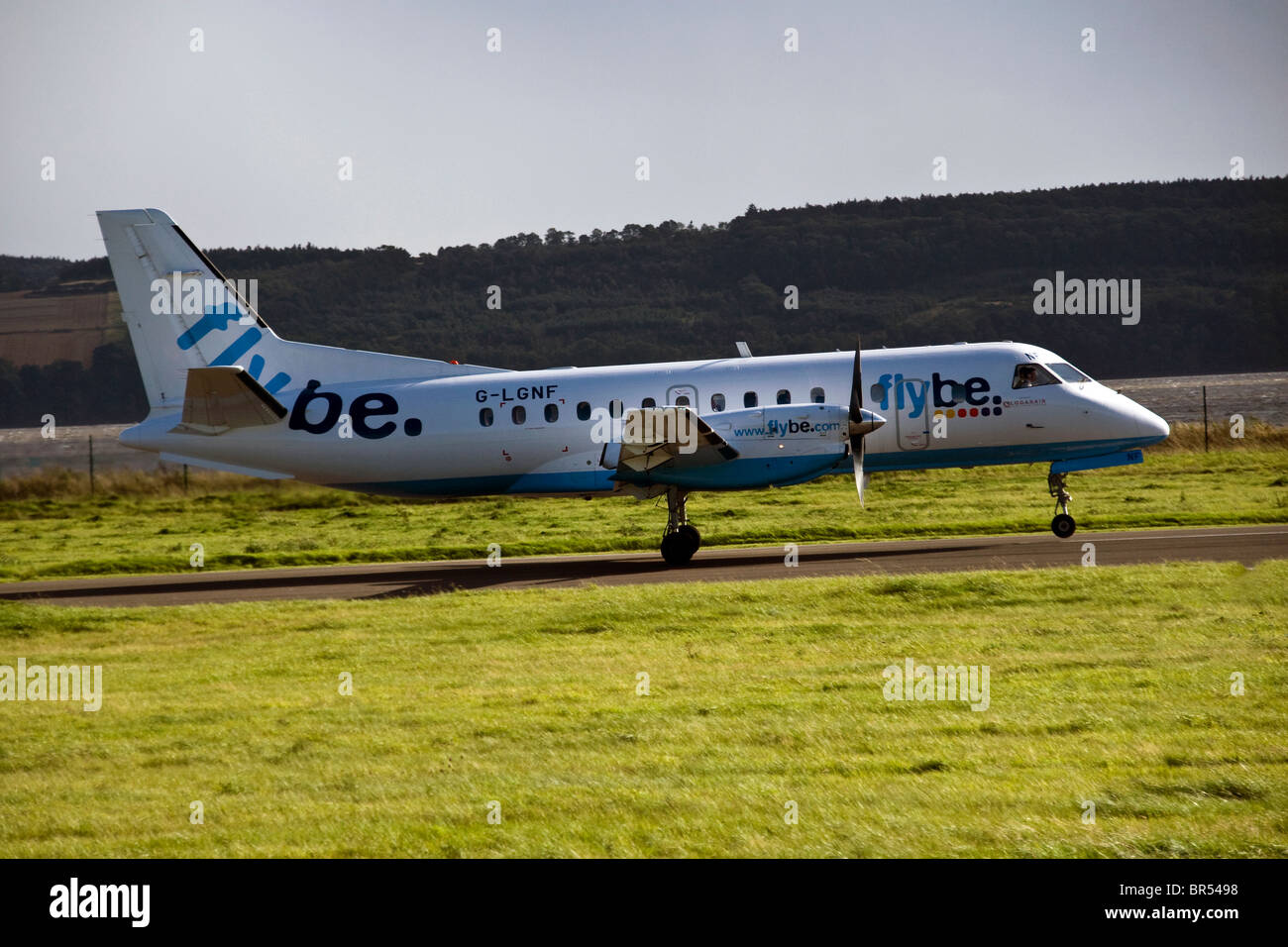 Flybe SAAB 340 turboprop plane accelerating along the runway taking off from the Dundee airport,UK Stock Photo