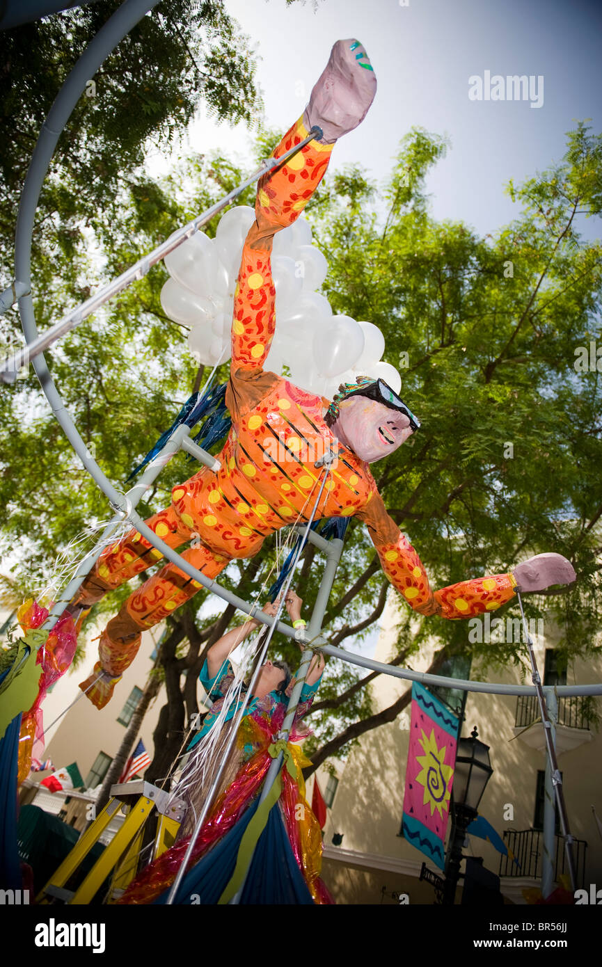 A flying man float at a parade in Santa Barbara. The parade features extravagant floats and costumes. Stock Photo