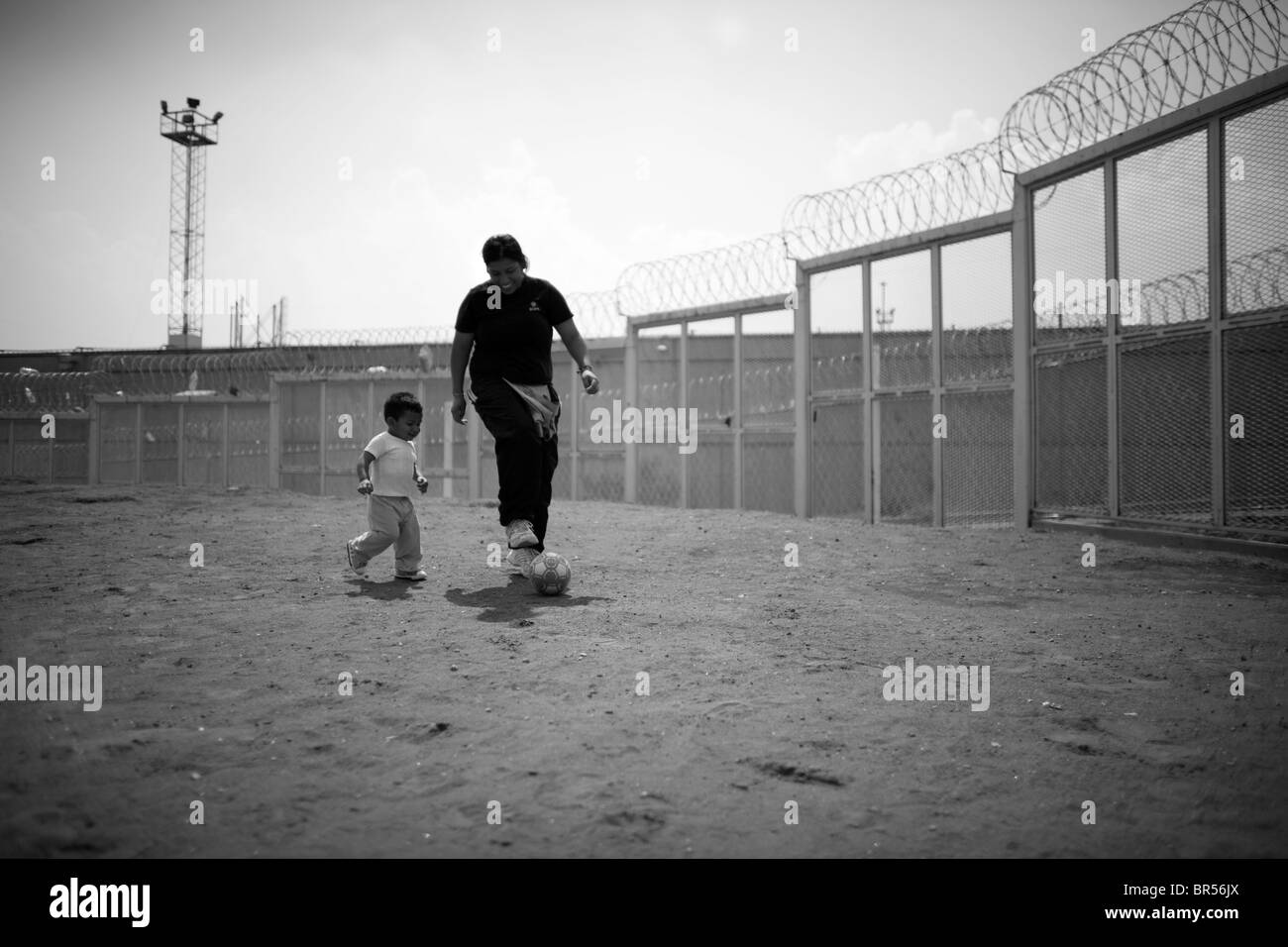 A prisoner plays soccer in a female penitentiary prison yard in Mexico D.F. Stock Photo