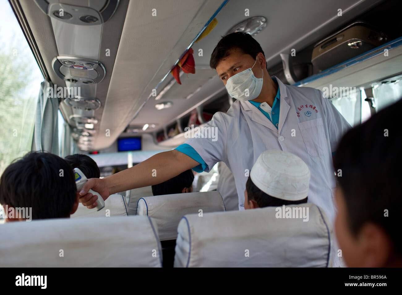 Testing for the H1N1 virus on a bus near Khotan Xinjiang China. Stock Photo