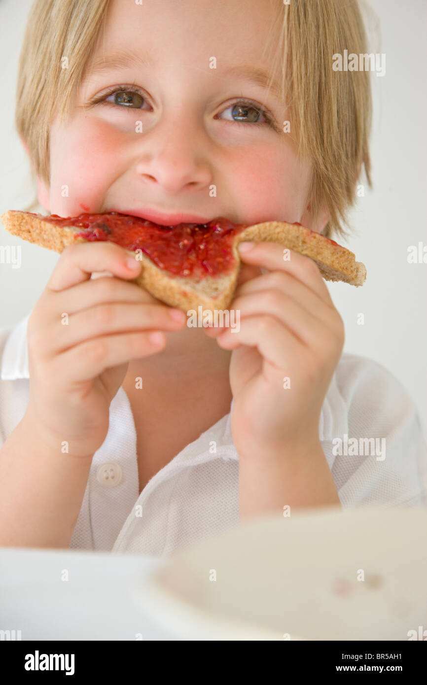 Boy Eating Jam on Toast Stock Photo Alamy