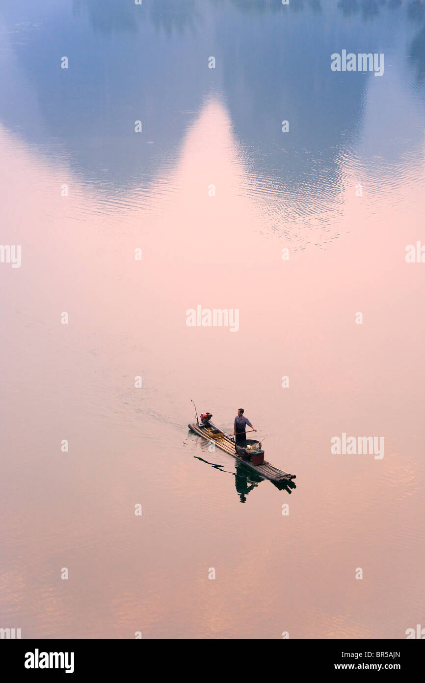 Fisherman on bamboo raft on Li River, Yangshuo, Guangxi, China Stock Photo