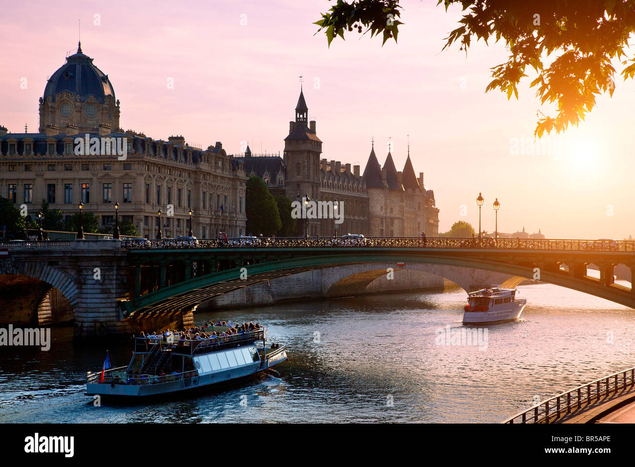 Europe, France, Paris (75), Tourist Boat on Seine River at Sunset Stock Photo