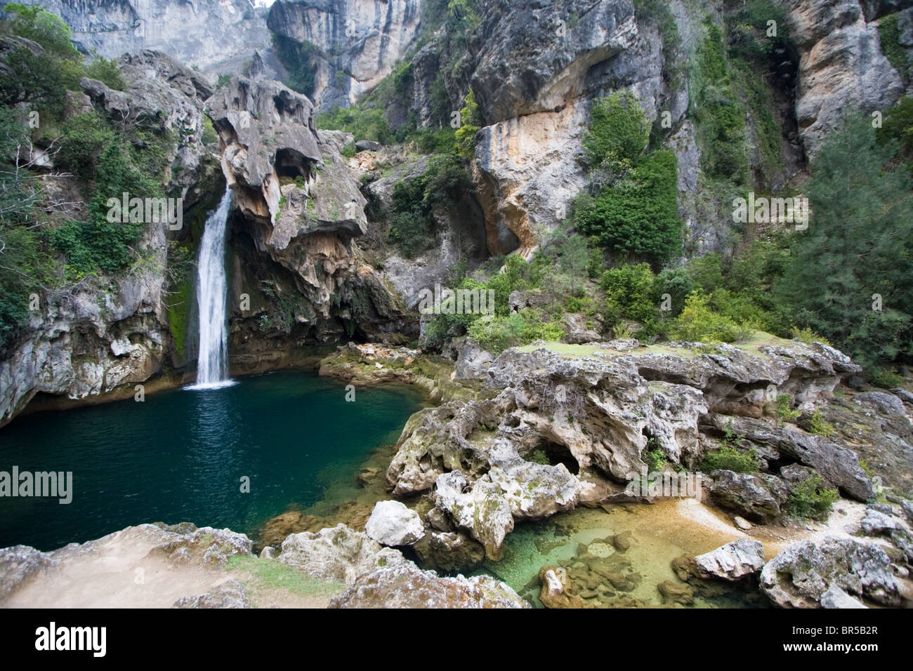Beautiful waterfall cascading into a blue lagoon, Cazorla National Park, Jaen Province, Andalucia, Spain Stock Photo
