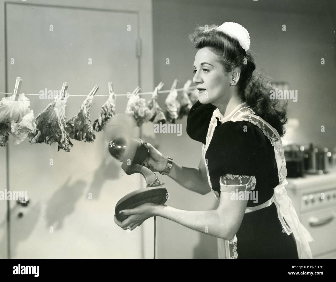 HOLLYWOOD CANTEEN 1944 Warner film with the Andrews Sisters. Here LaVerne Andrews tries drying lettuces. Stock Photo
