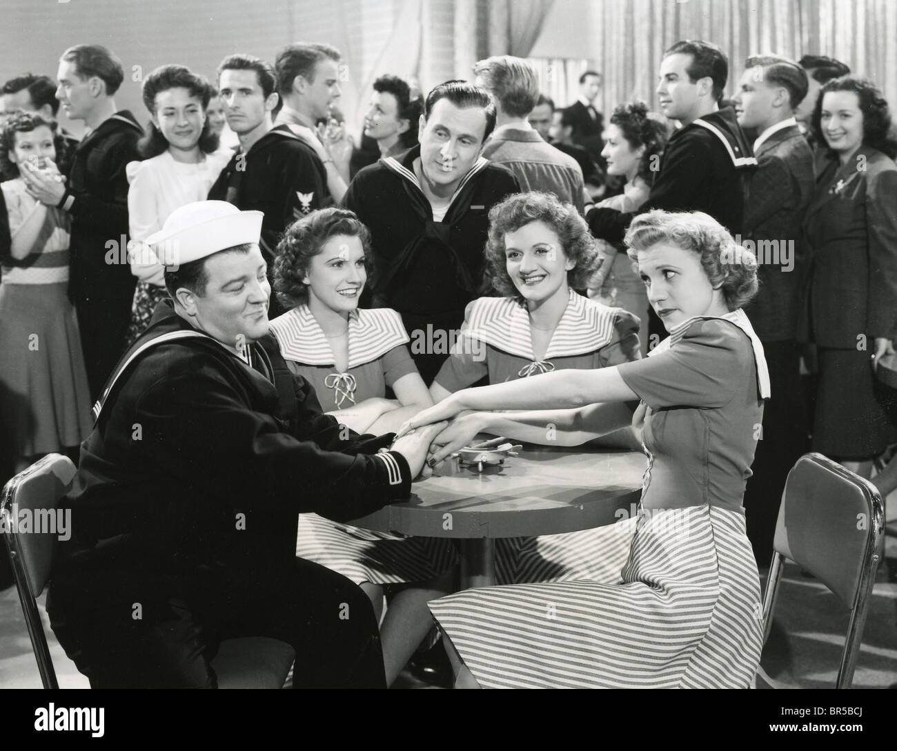 IN THE NAVY 1941 Universal film with the Andrews Sisters. From left Bud Abbott, Maxene,  Lou Costello, LaVerne, Patty Stock Photo