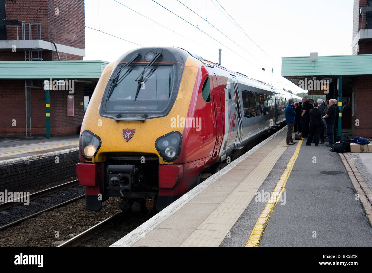 A Virgin Voyager express passenger train arriving at Wigan North Western station Stock Photo