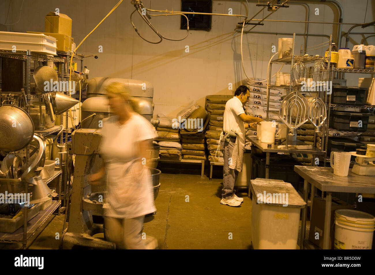 Two bakers working in an industrial bakery kitchen Stock Photo Alamy