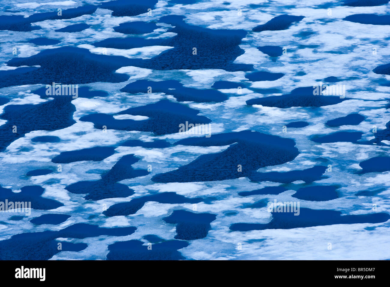 Melting ice on a mountain lake Stock Photo