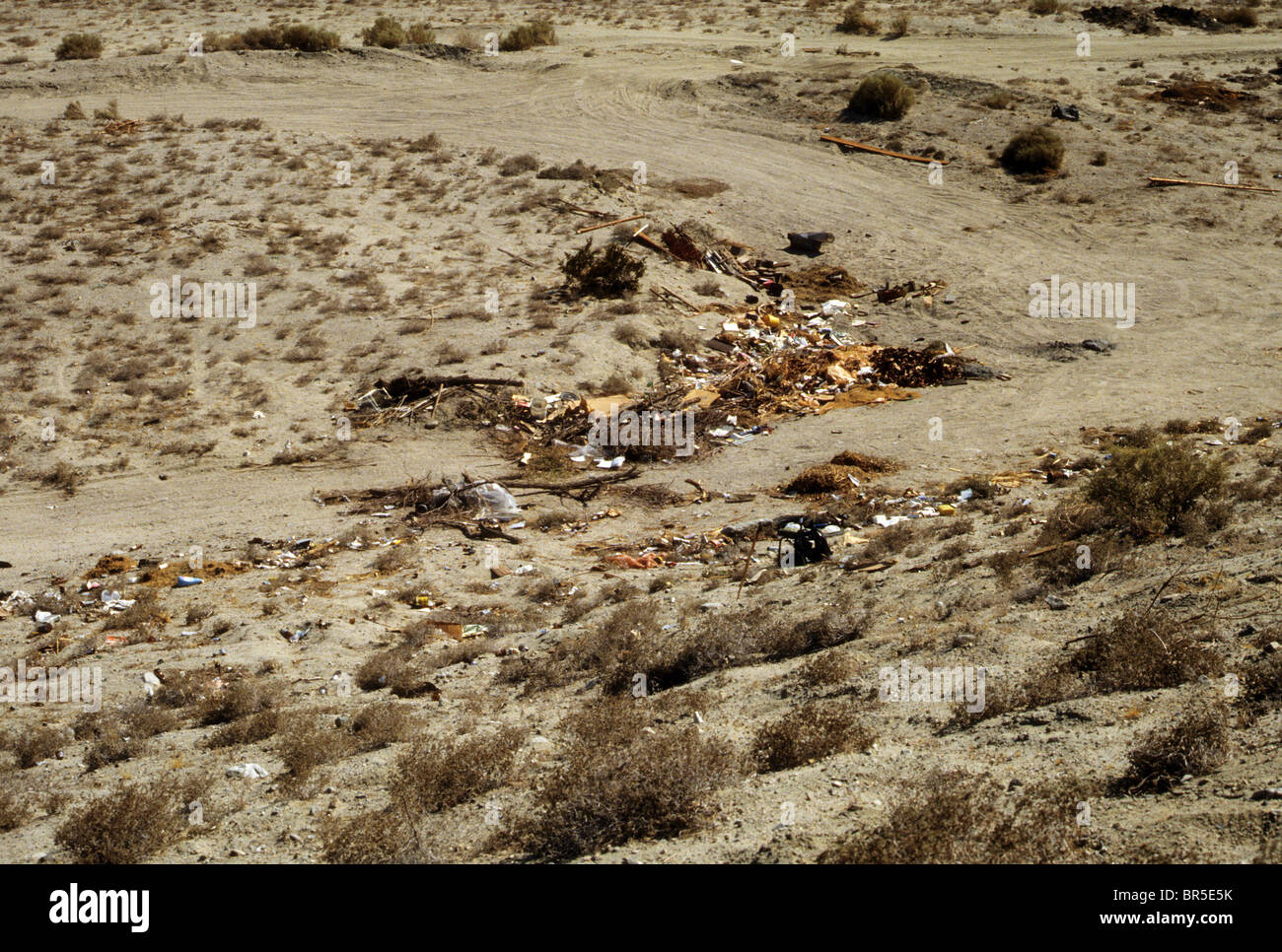litter desert trash rubbish dump careless wrong illegal rust pollute pollution Stock Photo