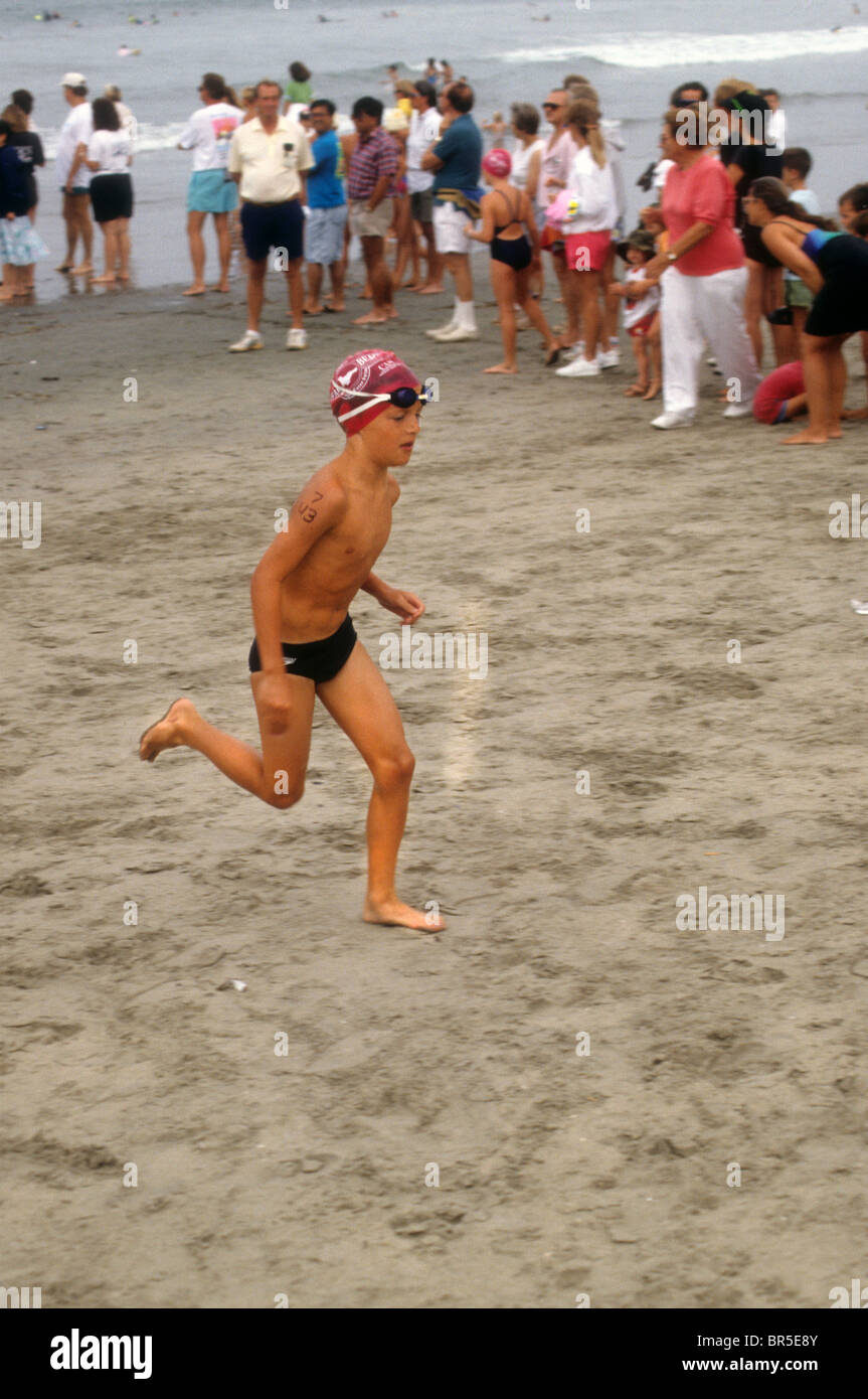 beach run race swim biathlon boy speedo sand ocean sea Stock Photo - Alamy