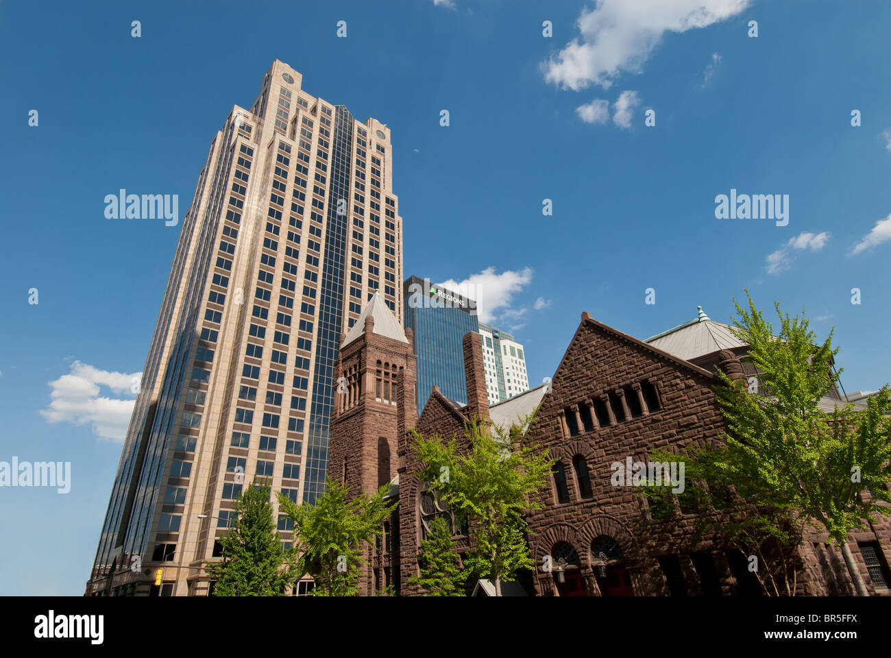 First United Methodist Church, built 1891, dwarfed by financial office towers in the city center of Birmingham, Alabama, USA Stock Photo