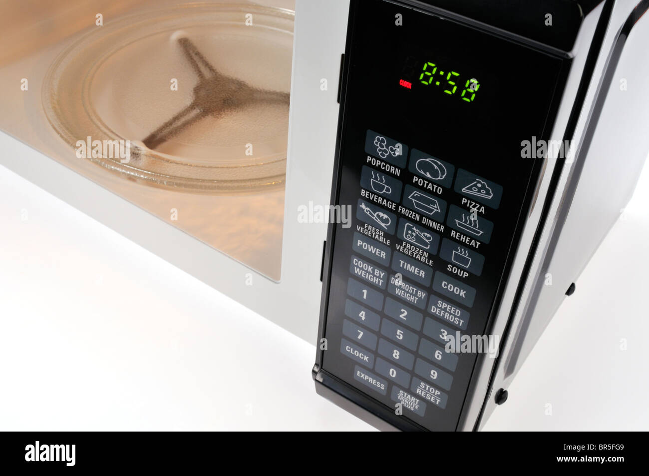 Microwave oven circular timer for one hour, analogue white. Stock Photo