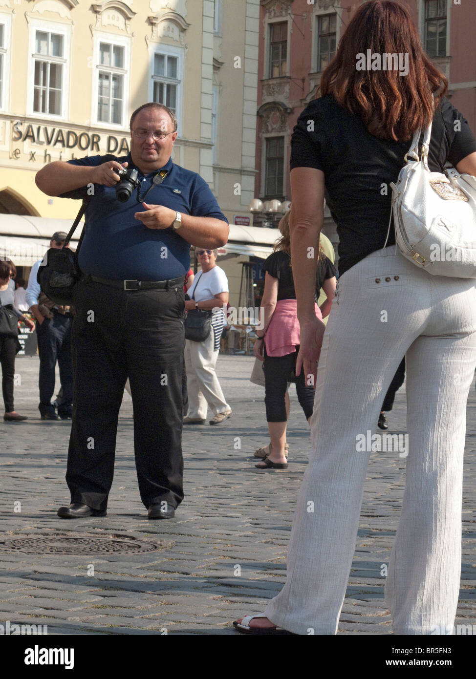 Big man taking photo of girl in Prague. Stock Photo