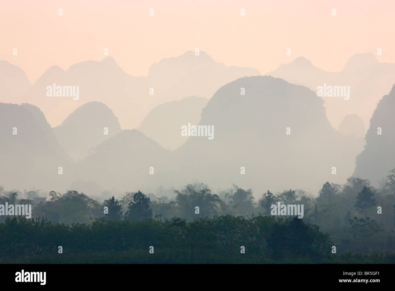 Karst hills in morning mist, Yangshuo, Guangxi, China Stock Photo
