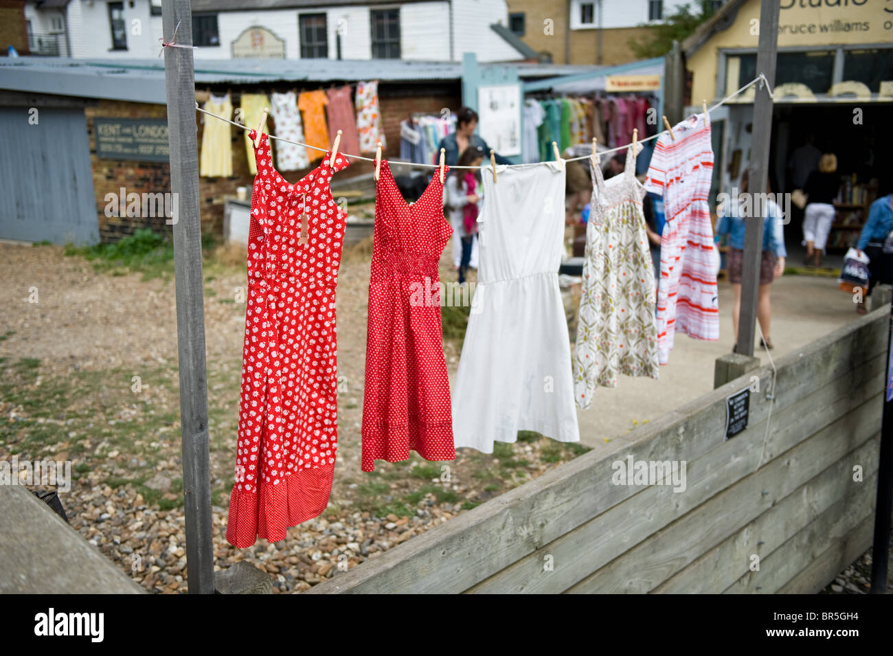 A washing line displaying second hand vintage dresses for sale