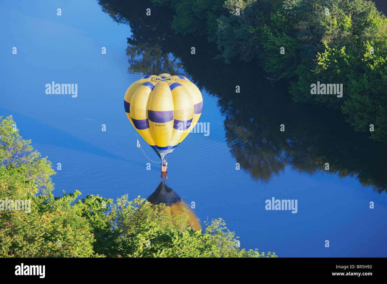 Hot air balloon dipping in the river Dordogne; France Stock Photo