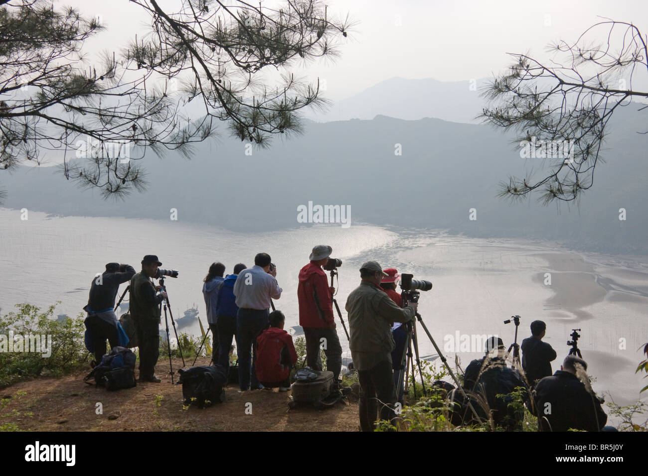 Tourists photographing along the East China Sea coast, Xiapu, Fujian, China Stock Photo