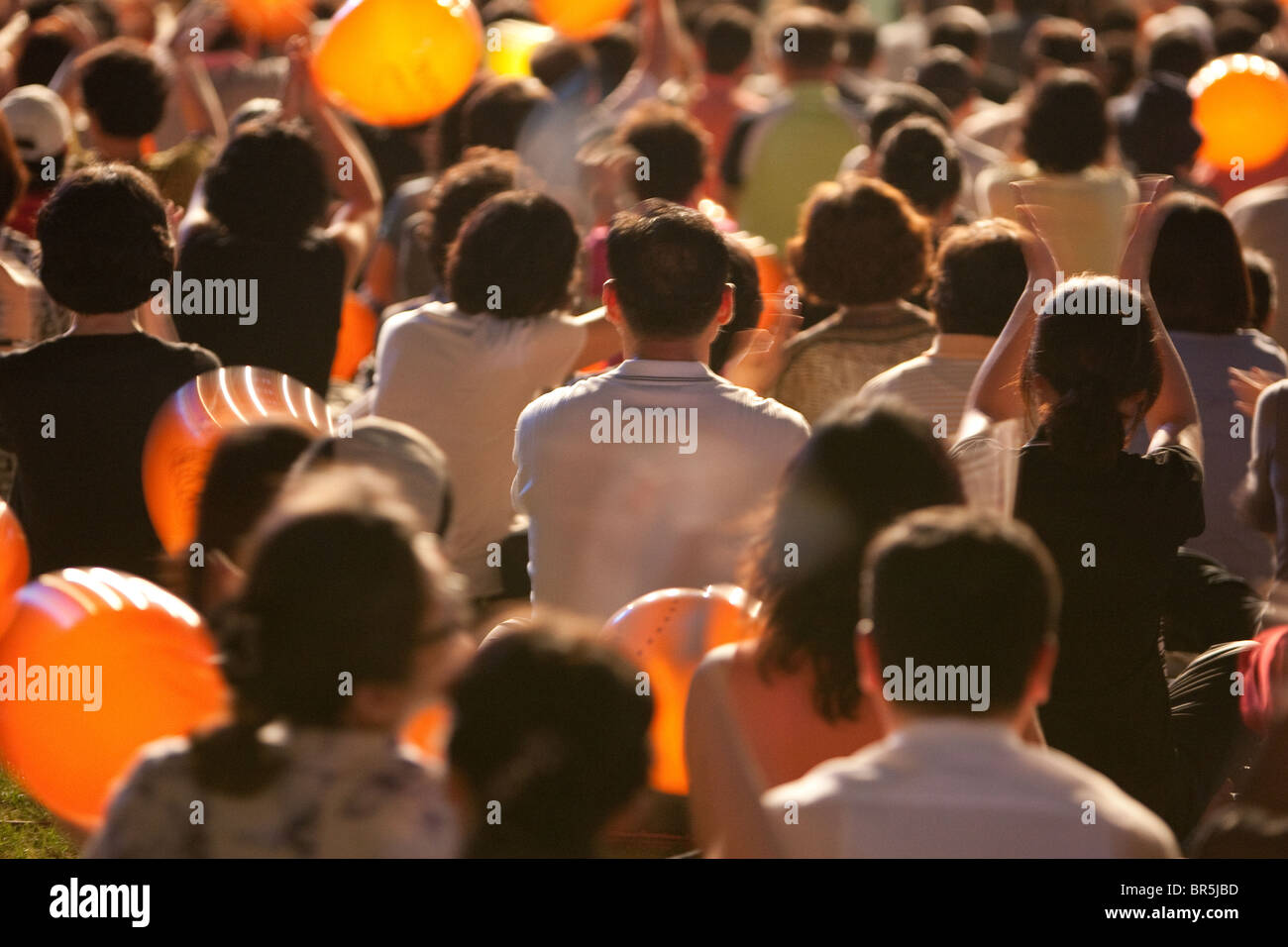 Audience listening at an open air music concert, in the evening, in Seoul, South Korea Stock Photo