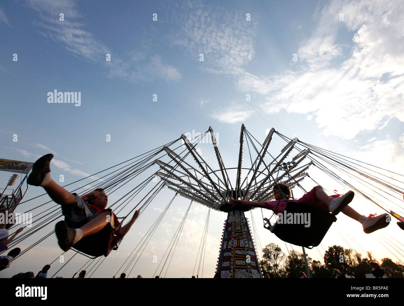Spinning Swan Ride Dusk silhouettes two riders on a spinning swing at a Cape Girardeau ...