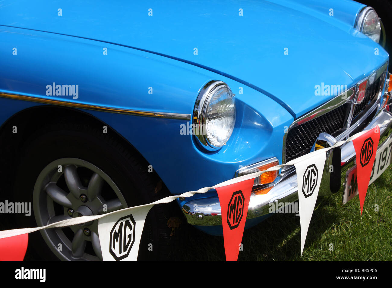 The front bumper, bonnet, grill and wheels of an MG Midget sports classic car. Stock Photo