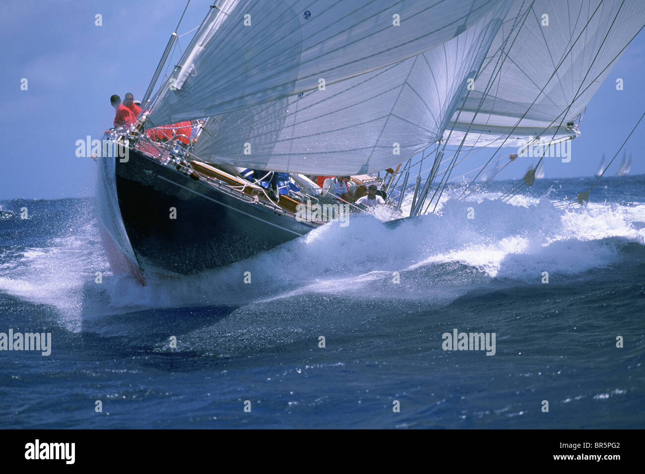 Sailboat cruising in blue water. Stock Photo